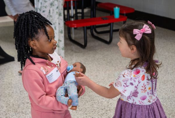 Ja'ziyah and Lily, both 3 years old, greet each other before the New Garden Church's Sunday assembly.