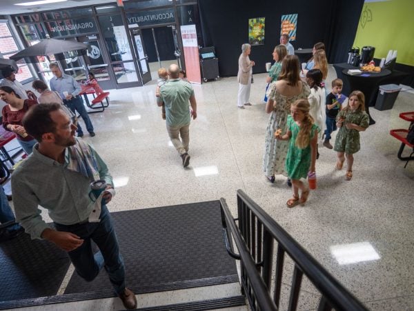 Members and guests gather in the school lobby before a Sunday assembly of the New Garden Church in Hermitage, Tenn.