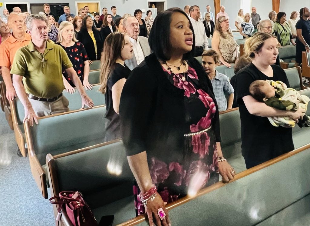 Phyllis Eason, wife of minister Donald T. Eason, sings at the Metro Church of Christ in Sterling Heights, Mich. Beside her is Embrace Grace graduate Brooklyn Covington, with her baby, Bronx.
