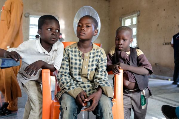 Boys wait to be seen by a doctor at a Hope Springs International clinic.