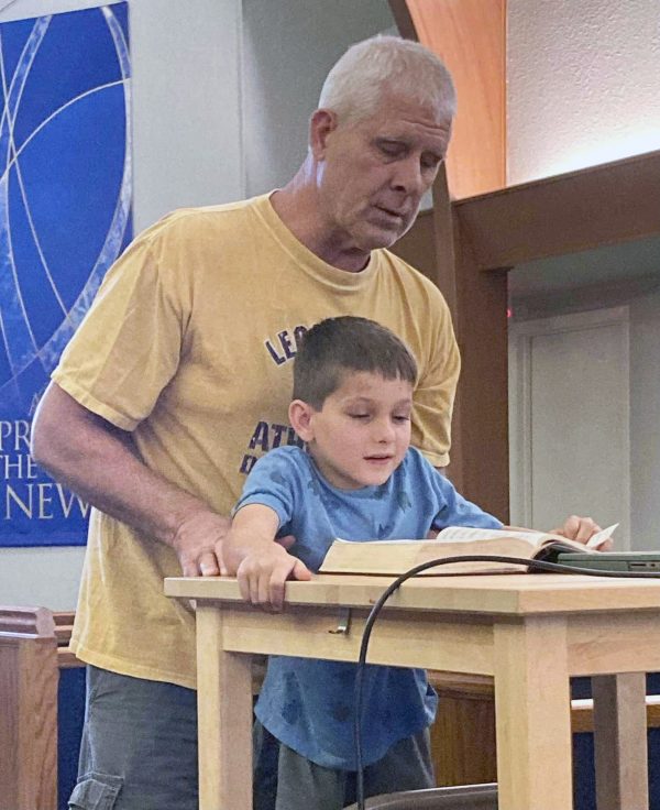 Ben Stark leads singing on a Wednesday night with a little assistance from his grandfather, Kevin Stark, a deacon of the La Grange Church of Christ in Texas.