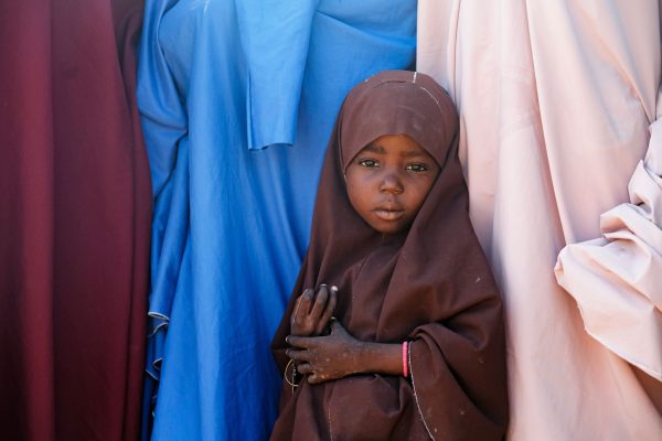 A Muslim girl waits in line with women outside a Hope Springs International clinic.