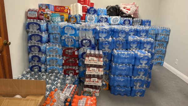 The Lincoln Avenue Church of Christ distributes stacks of water bottles and other items donated by other area churches.