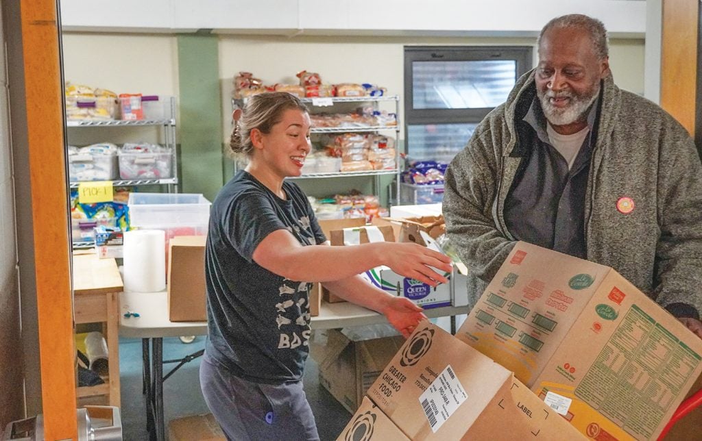 Audrey Bowen supervises a delivery of donations for the food pantry of the Lakeview Church of Christ in Chicago. The ministry experienced a spike in demand as immigrants bused from border towns in Texas arrived in the Windy City.