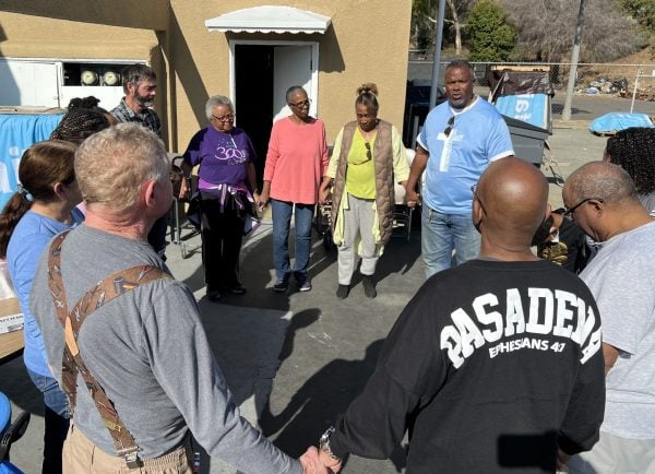 Christians helping with the Lincoln Avenue church's disaster relief effort gather in a circle to pray.