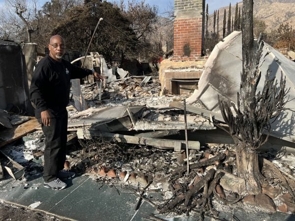 Senior minister Rodney Davis visits the remains of a Lincoln Avenue Church of Christ member's burned home.