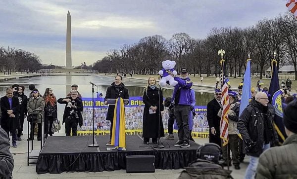 Jeff Abrams holds up a teddy bear representing the children of Ukraine during a rally outside the Lincoln Memorial in Washington.