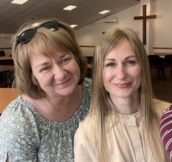 Svetlana Shevchenko, right, stands with translator Inna Kuzmenko at during a 2024 ministry retreat in Irpin, Ukraine.