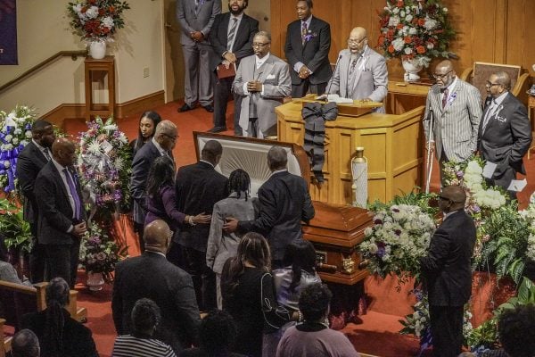 Mourners visit the casket holding Andrew J. Hairston as Chris Turner leads singing at the Simpson Street Church of Christ in Atlanta.