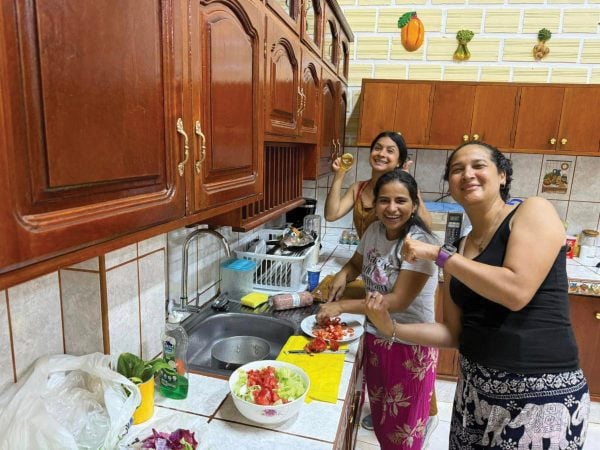 Members of the Iquitos, Peru, team prepare a meal in their new home.