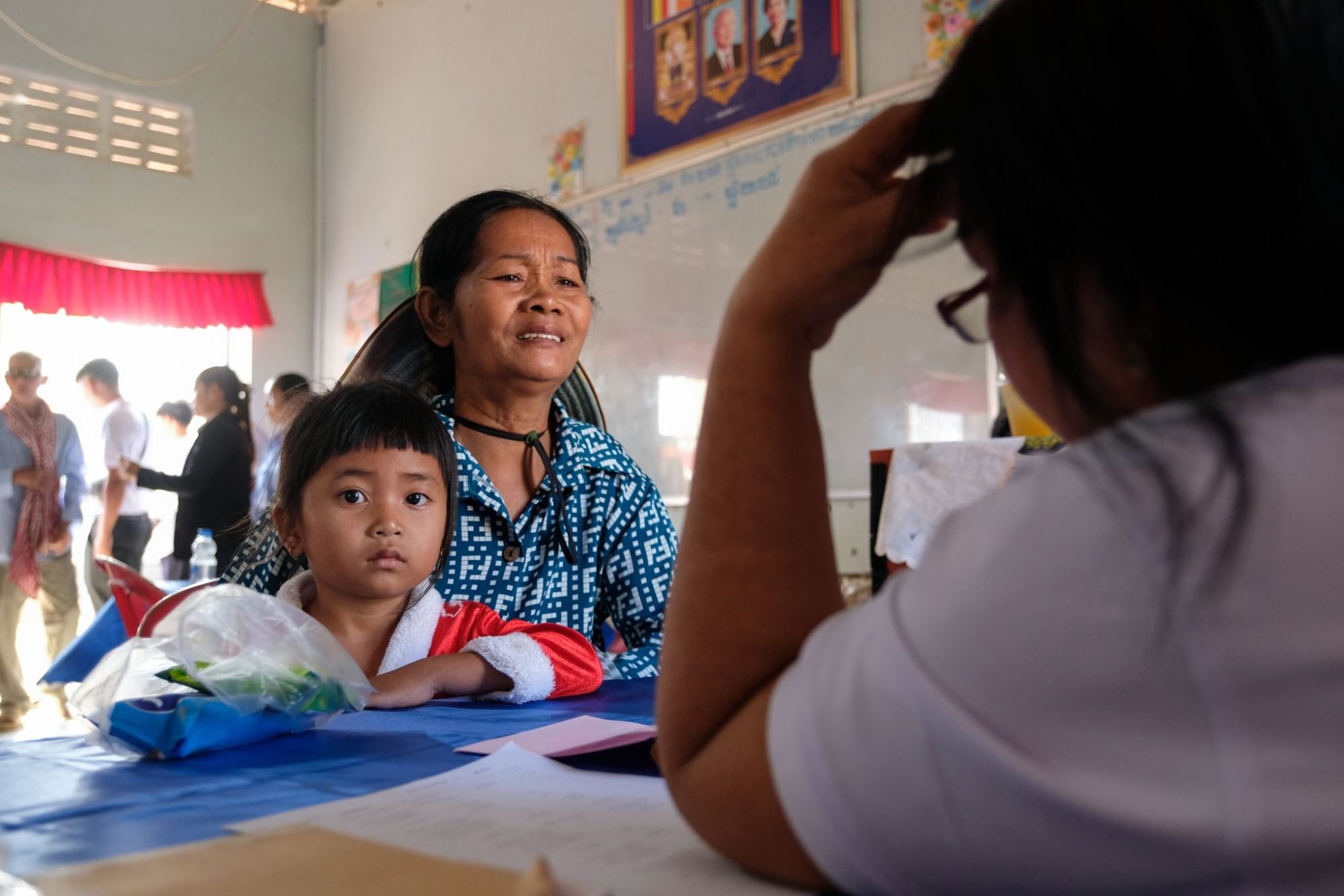 A doctor with Cambodia Christian Ministries fills out a patient's intake form in Prey Svay, Cambodia.