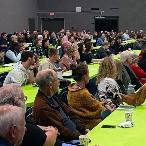 In the gym of the North MacArthur Church of Christ, church members listen to Trey Morgan during Affirming the Faith.