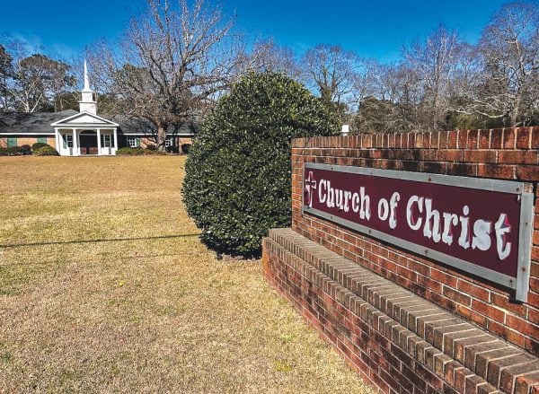 A weather-worn sign invites the people of Statesboro to worship with the Church of Christ.