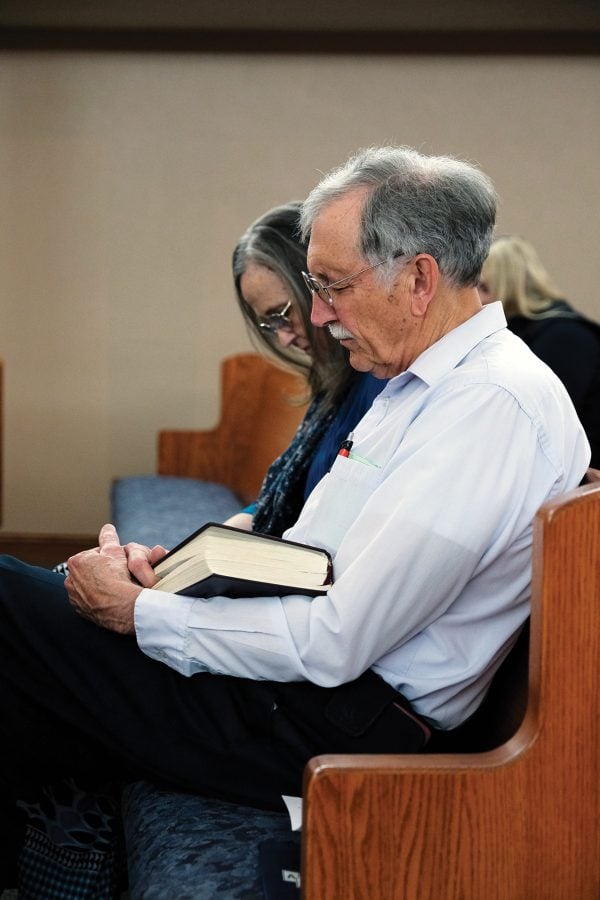 Everett and Ann Hinton bow their heads for a prayer at the Hastings Church of Christ in Nebraska.