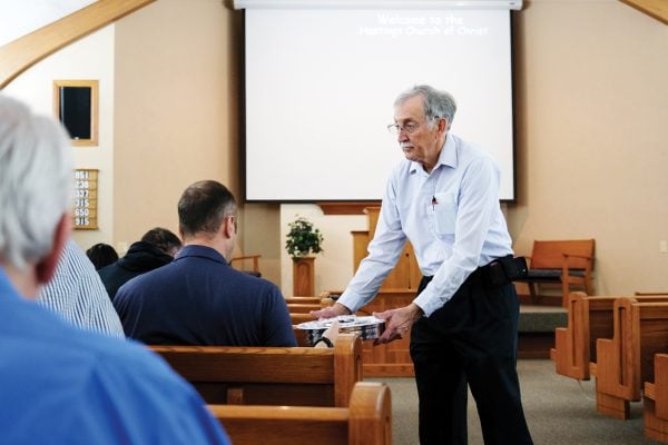 Everett Hinton serves communion on a recent Sunday morning at the Hastings Church of Christ.