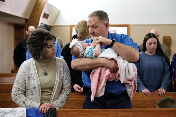 DudLee Brennfoerder holds his granddaughter during a Hastings Church of Christ Sunday service.