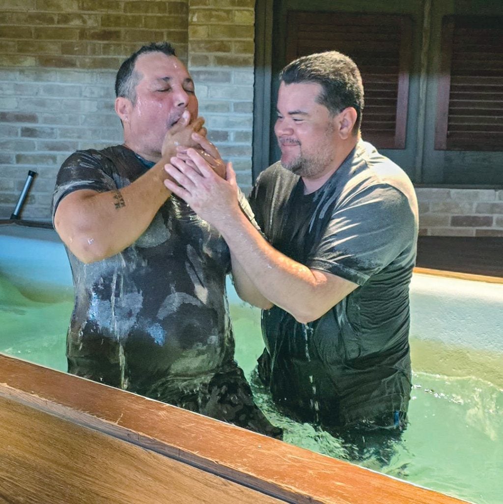 Lenin Munguia, Hispanic minister for the Waterview Church of Christ, baptizes Venezuelan immigrant Faiver Alejandro.