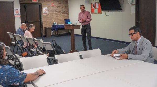 Juan Carlos Martinez, right, prepares to lead Spanish-language Bible class for the West Broward Church of Christ in Plantation, Fla.
