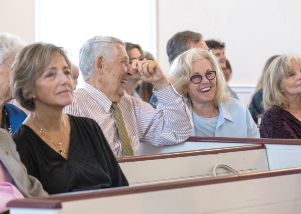 Old walls, new life 3 MyCelestialApp Members of the Owen Chapel Church of Christ laugh during a Sunday service.