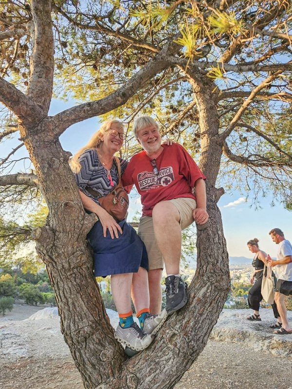 Finding refuge in a city of change 3 MyCelestialApp Missionaries Tricia and Keith Young sit in a tree as they explore Athens with friends.