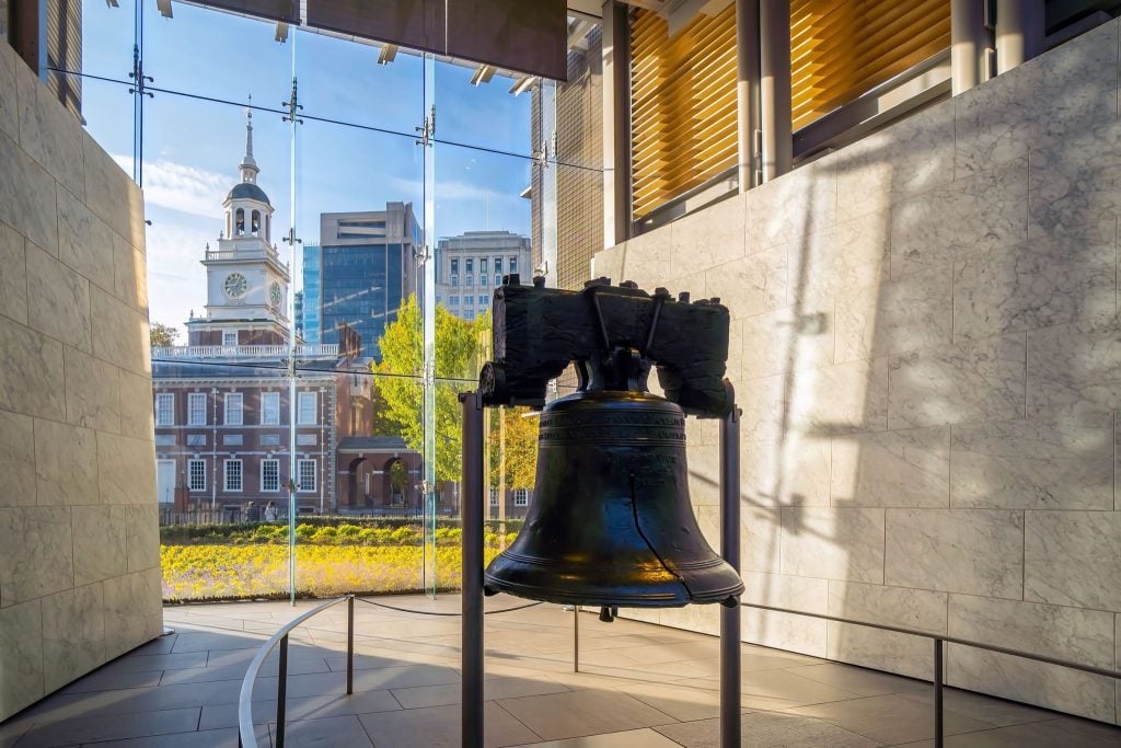 The Liberty Bell can be seen in Philadelphia, with Independence Hall in the background.