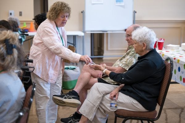 How churches are rethinking senior ministry 4 MyCelestialApp Helper and retired nurse Inez Stubblefield hands a plastic heart to Volunteer Helen Huffines.