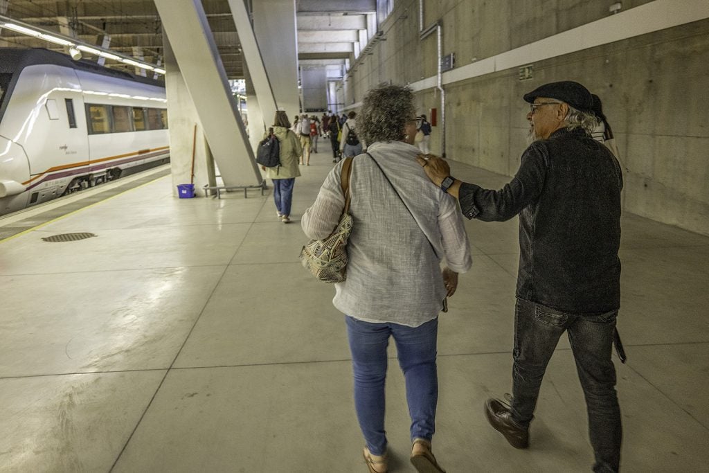 Luisa and Pedro Andrade walk through a train station in Vigo, Spain.