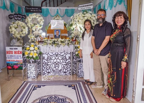 From left, Ngan Huynh, Erik Tryggestad and Huynh Hong Hue (“Miss Eight”) stand next to the casket and memorial for Nguyen Chau Son.