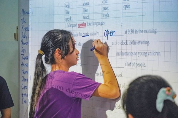 A student at Connor English School practices verb tenses during a Thursday evening class.