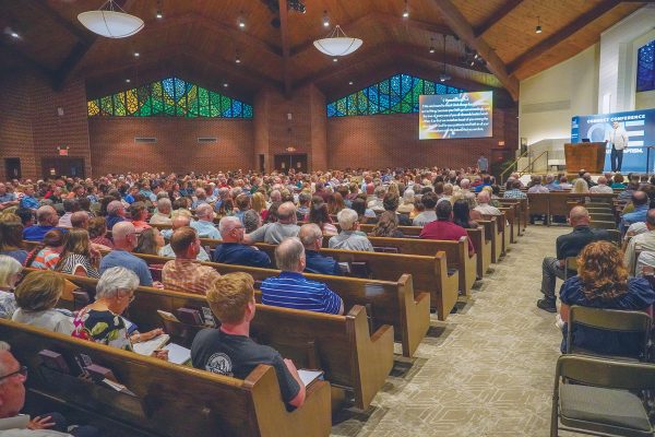 A packed auditorium of Connect Conference participants listens as Matt Miller preaches on "Living Humble: A Shared Posture."
