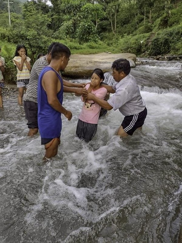 Christians baptize a new believer in Dhading Besi, Nepal, in 2021.