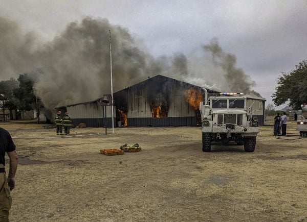 Firefighters respond as a blaze consumes Rhodes Hall on the campus of Quartz Mountain Christian Camp in southwest Oklahoma.