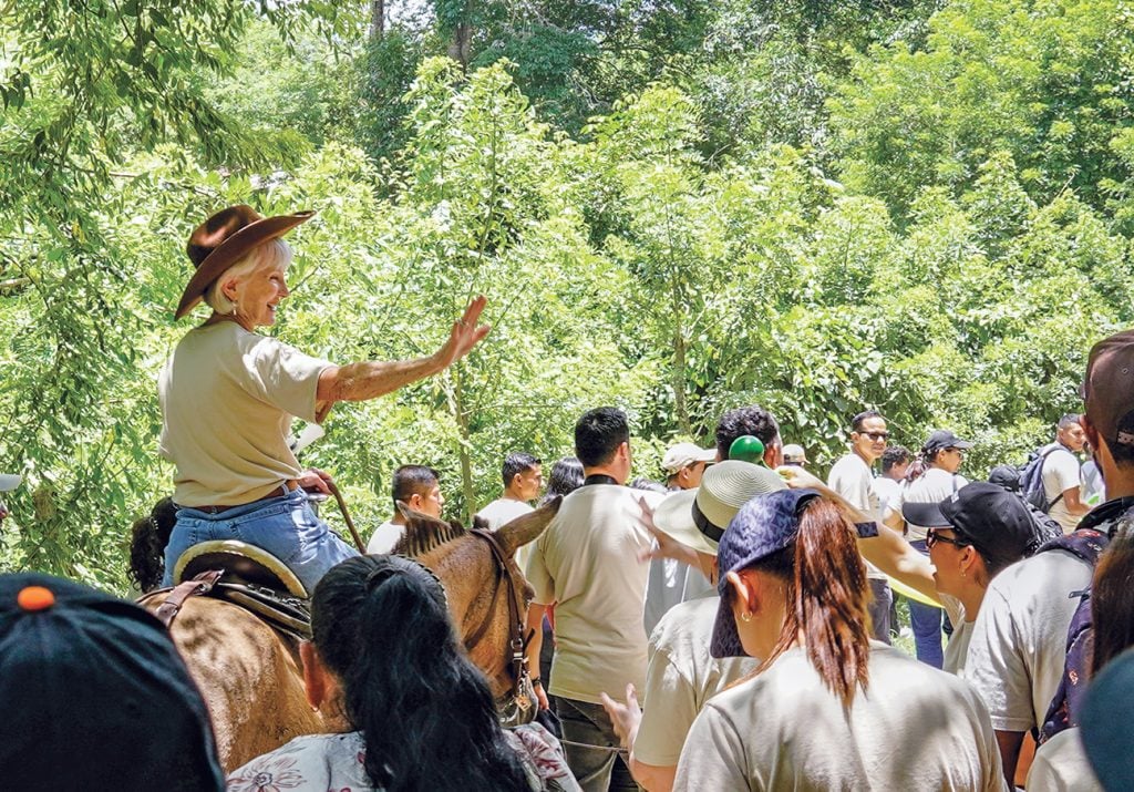 Predisan founder Doris Clark waves to supporters from horseback as she rides to CEDECO.